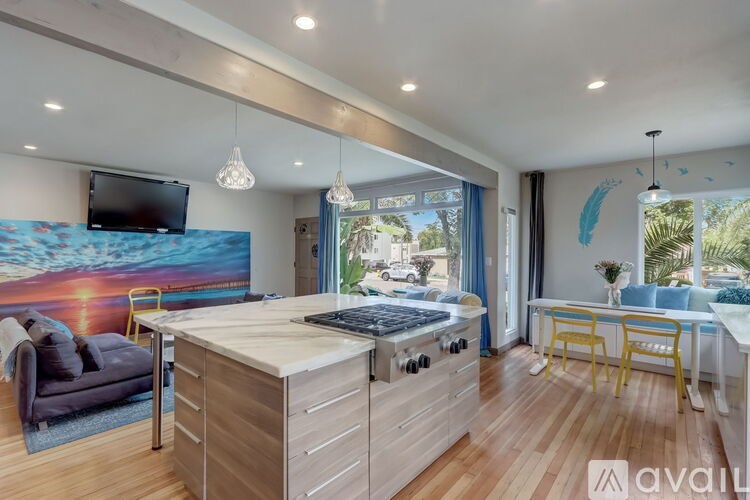 A modern kitchen with wooden cabinets and a large island.