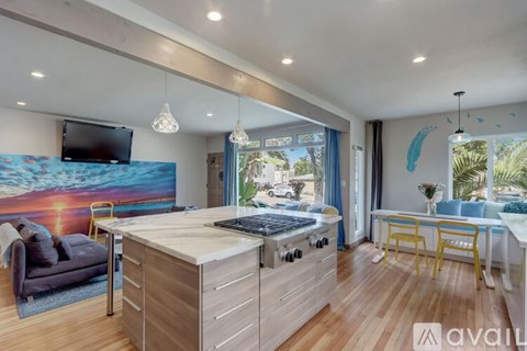 A modern kitchen with wooden cabinets and a large island.
