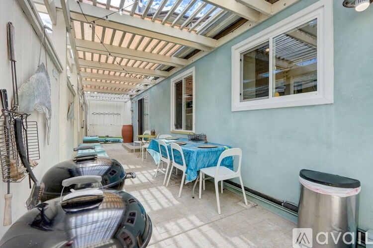A patio with a table set for dining and chairs.