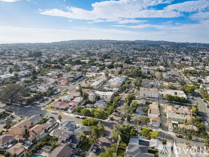 A bird's eye view of a residential area with houses and streets.