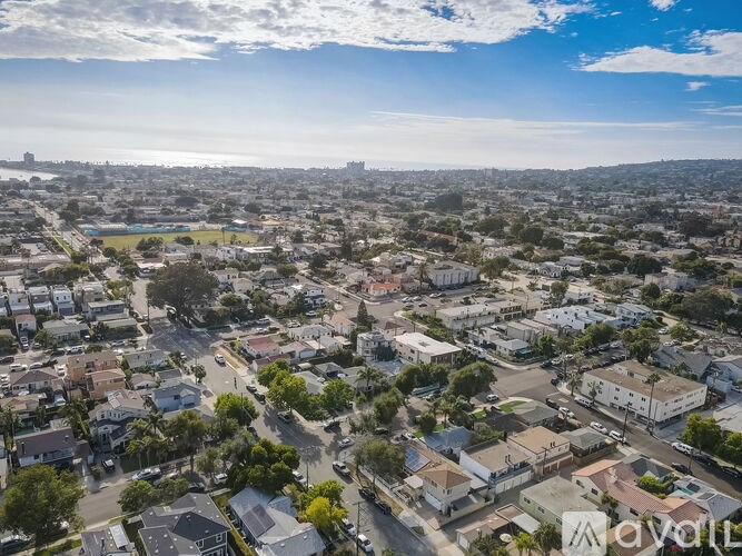 A bird's eye view of a residential area with houses and streets.