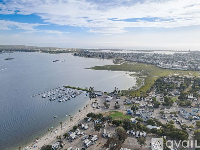 A marina with boats and a parking lot.