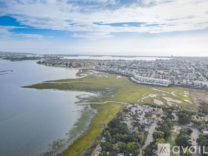 An aerial view of a city with a large body of water in the foreground.