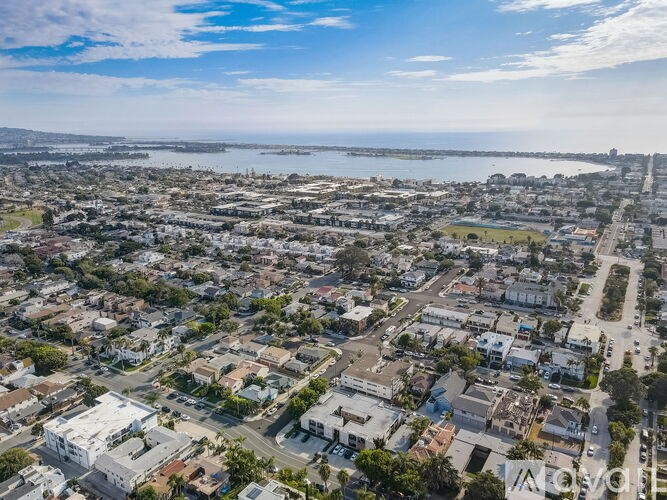 A bird's eye view of a residential area with houses and streets.