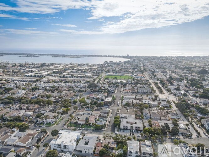 A bird's eye view of a residential area with houses and streets.
