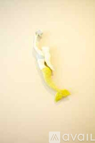 A white and yellow object with a long tail.