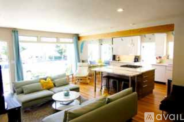 A living room with a couch, a chair, and a coffee table.