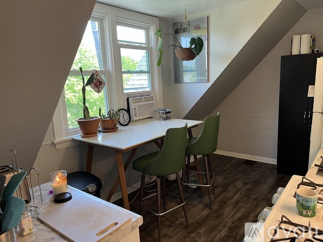 A kitchen with a table and chairs.