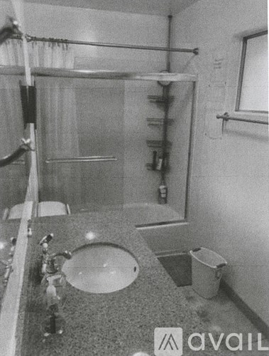 A bathroom with a sink, toilet, and shower.