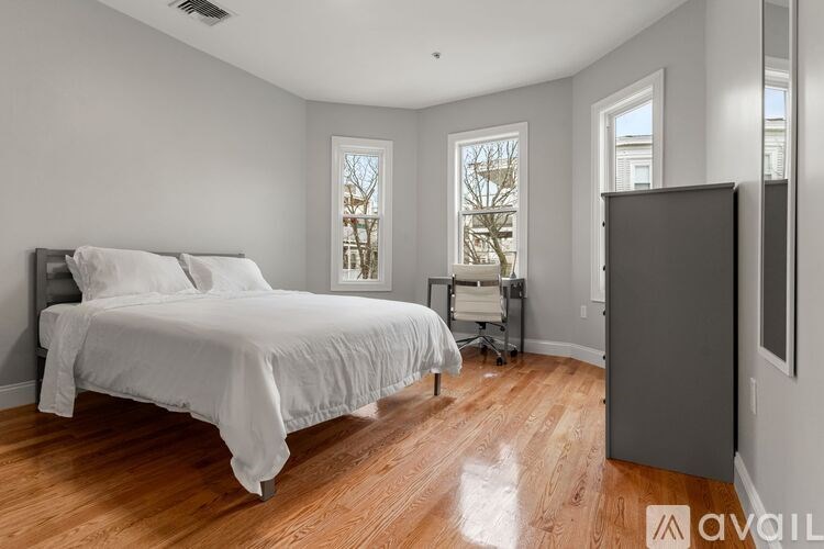 A bathroom with a toilet, sink, and shower.