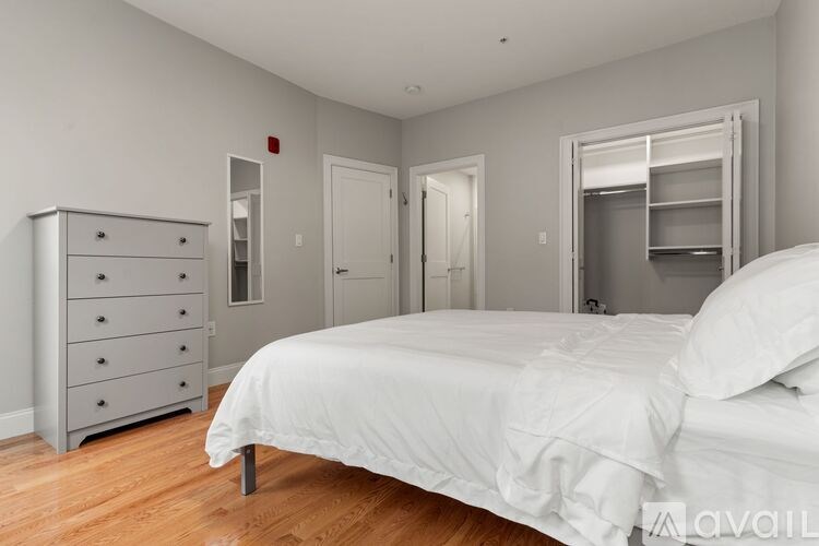 A bathroom with a toilet, sink, and walk-in shower.