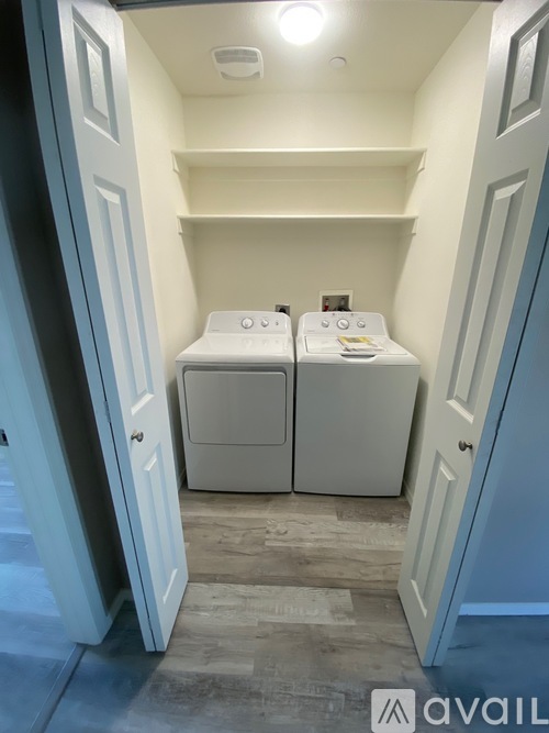 A small bathroom with two toilets and a sink.