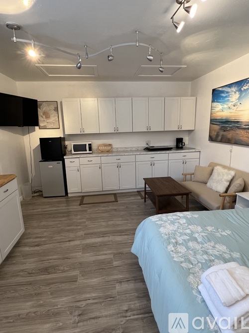 A kitchen with white cabinets and a microwave above the stove.