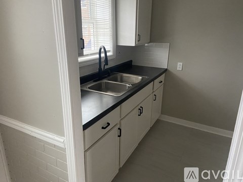 A kitchen with a sink and cabinets.