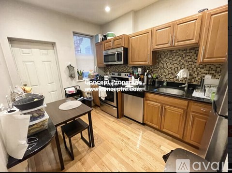 A kitchen with wooden cabinets and a black countertop.