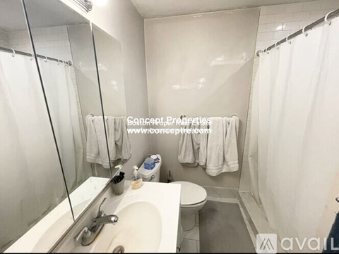 A bathroom with a sink, toilet, and shower.