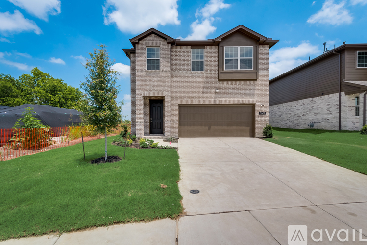 A house with a garage and a driveway is available for sale.