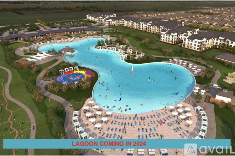 A large outdoor pool with a slide and people in it.
