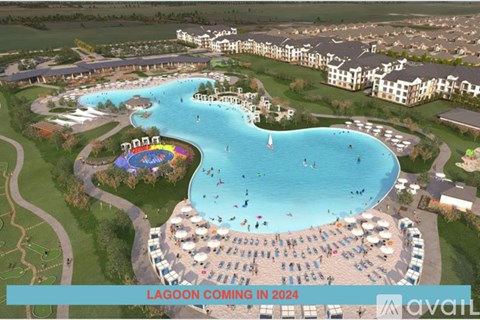 A large outdoor pool with a slide and people in it.