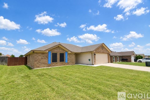 A house with a brown roof and a garage door.