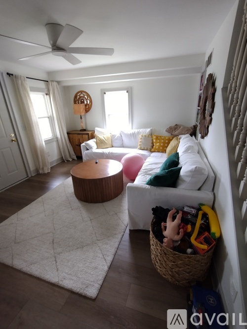 A bedroom with a large bed and wooden floors.