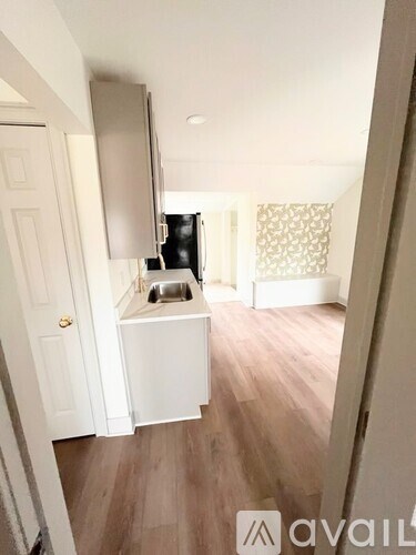 A small kitchen with a sink and a refrigerator.
