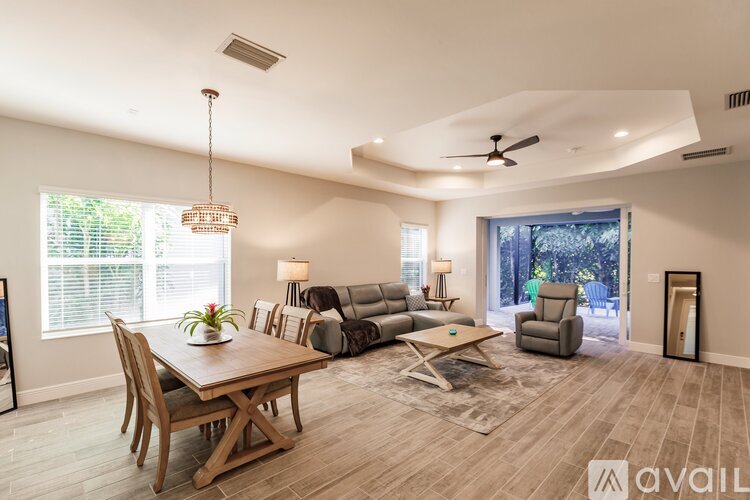 A well-lit living room with a dining table and a couch.