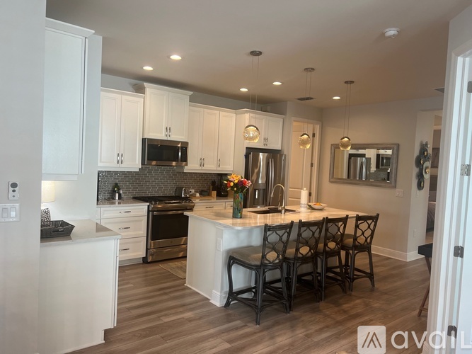 A kitchen with a dining table and chairs.