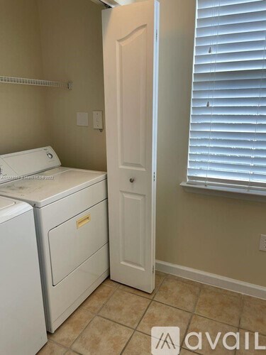 A small laundry room with a washer and dryer.