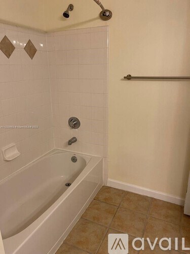 A bathroom with a white tub and a shower with a glass door.
