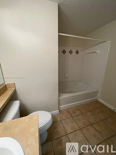 A bathroom with a toilet, a bathtub, and a shower.