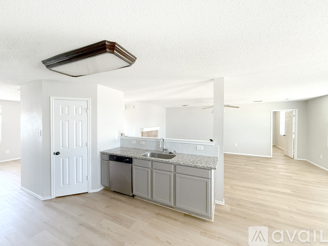 A kitchen with a black stove top oven and a black microwave.