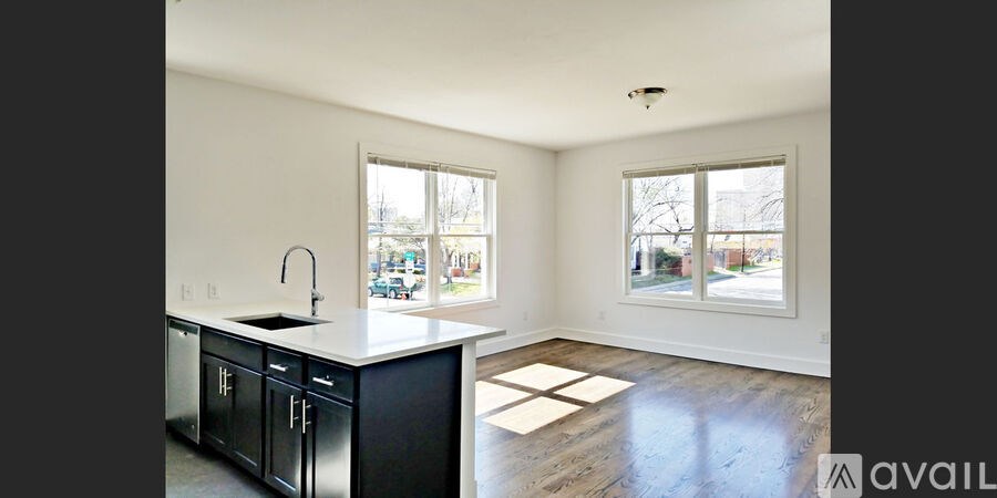 A kitchen with black cabinets and a white countertop.