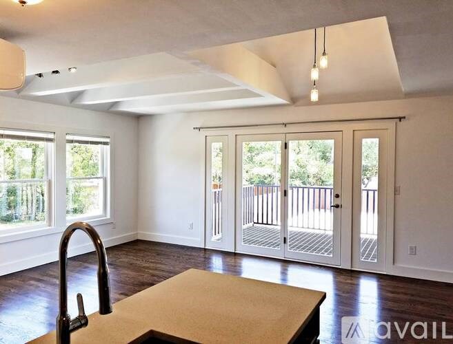 A kitchen with a sink and a table in the middle of the room.