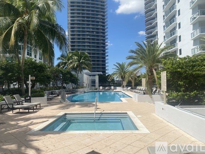 A pool area with a small pool and a larger pool in the middle.