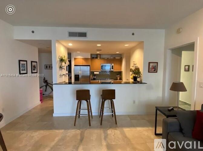 A living room with a bar stool and a couch.