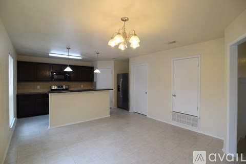 A kitchen area with a counter and cabinets.