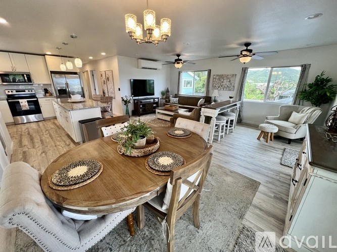 A well-lit, spacious kitchen and dining area with a wooden table set for a meal.