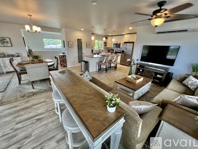 A living room with a long wooden table and chairs.