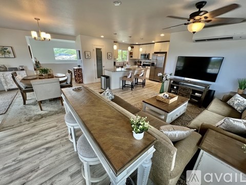 A living room with a long wooden table and chairs.
