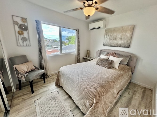 A bedroom with a large bed and a ceiling fan.