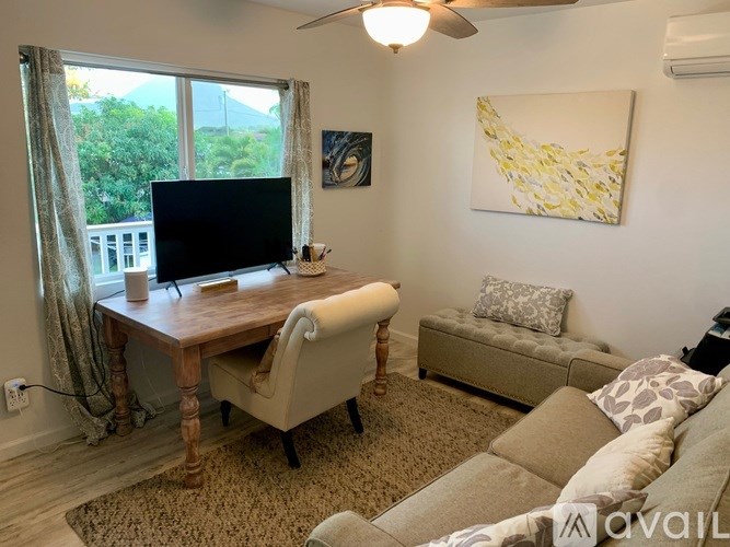 A living room with a couch, chair, and television.