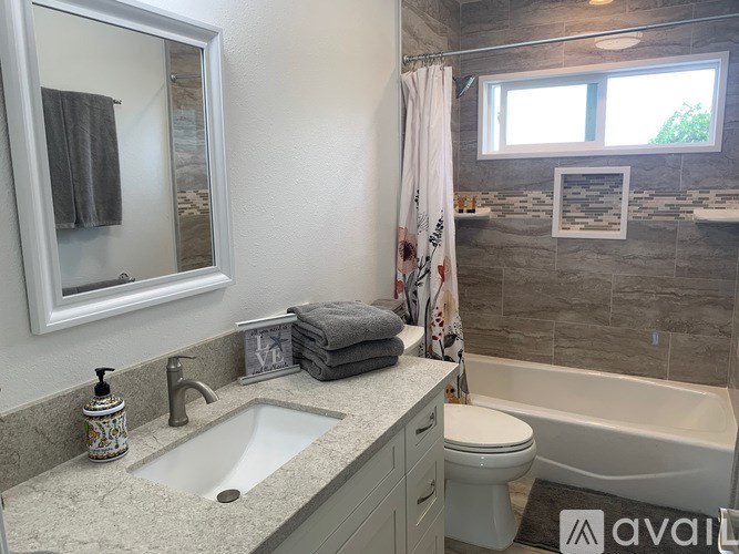 A bathroom with a sink, toilet, and bathtub.
