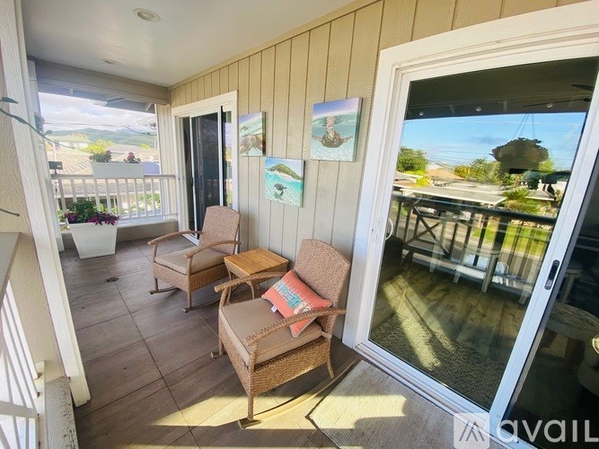 A balcony with a chair and a table.