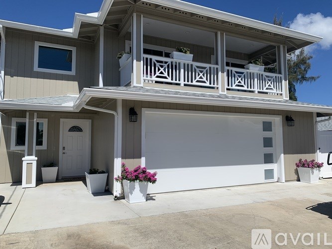A two-story house with a balcony and a garage.