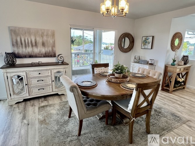 A dining room with a wooden table and chairs.