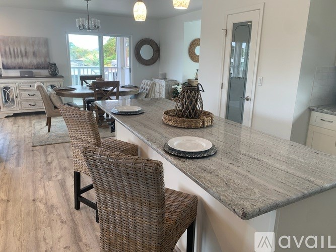 A kitchen with a table and chairs in the foreground.