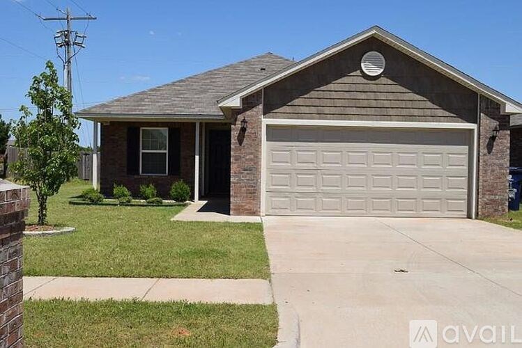 A house with a garage door and a driveway.