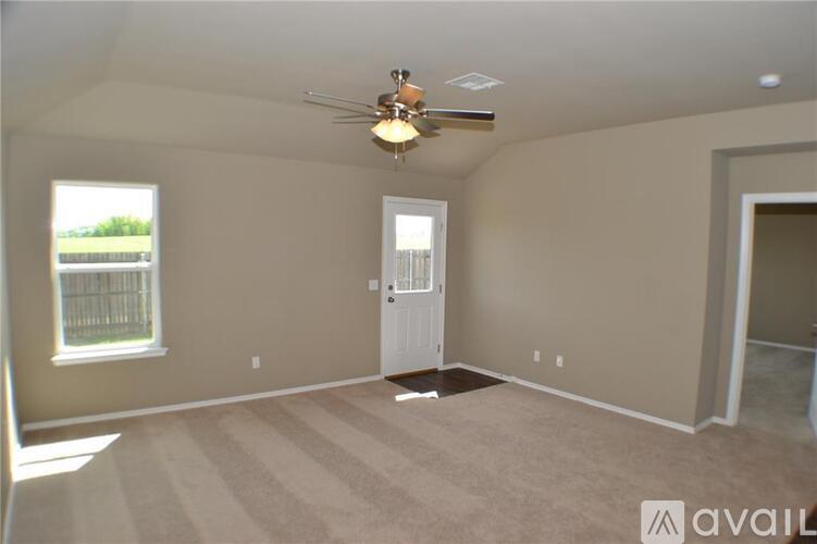 A room with a fan and a door is available for rent.