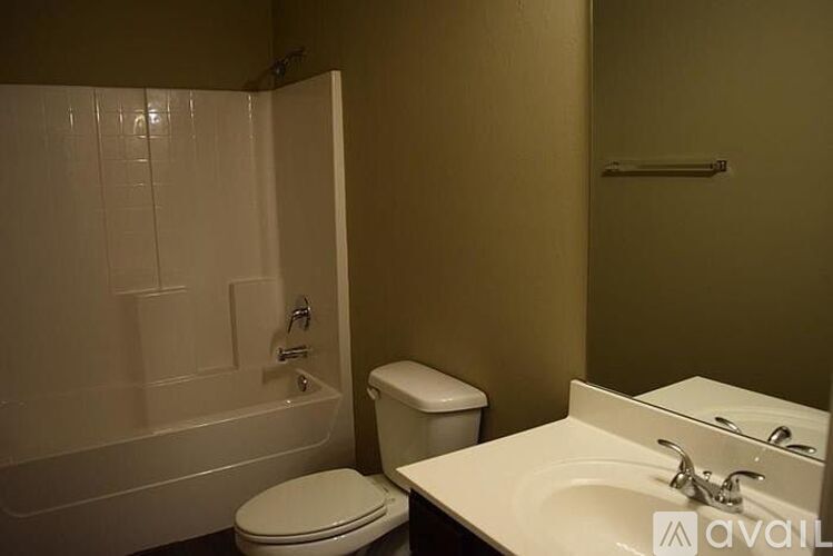A bathroom with a toilet, sink, and bathtub.